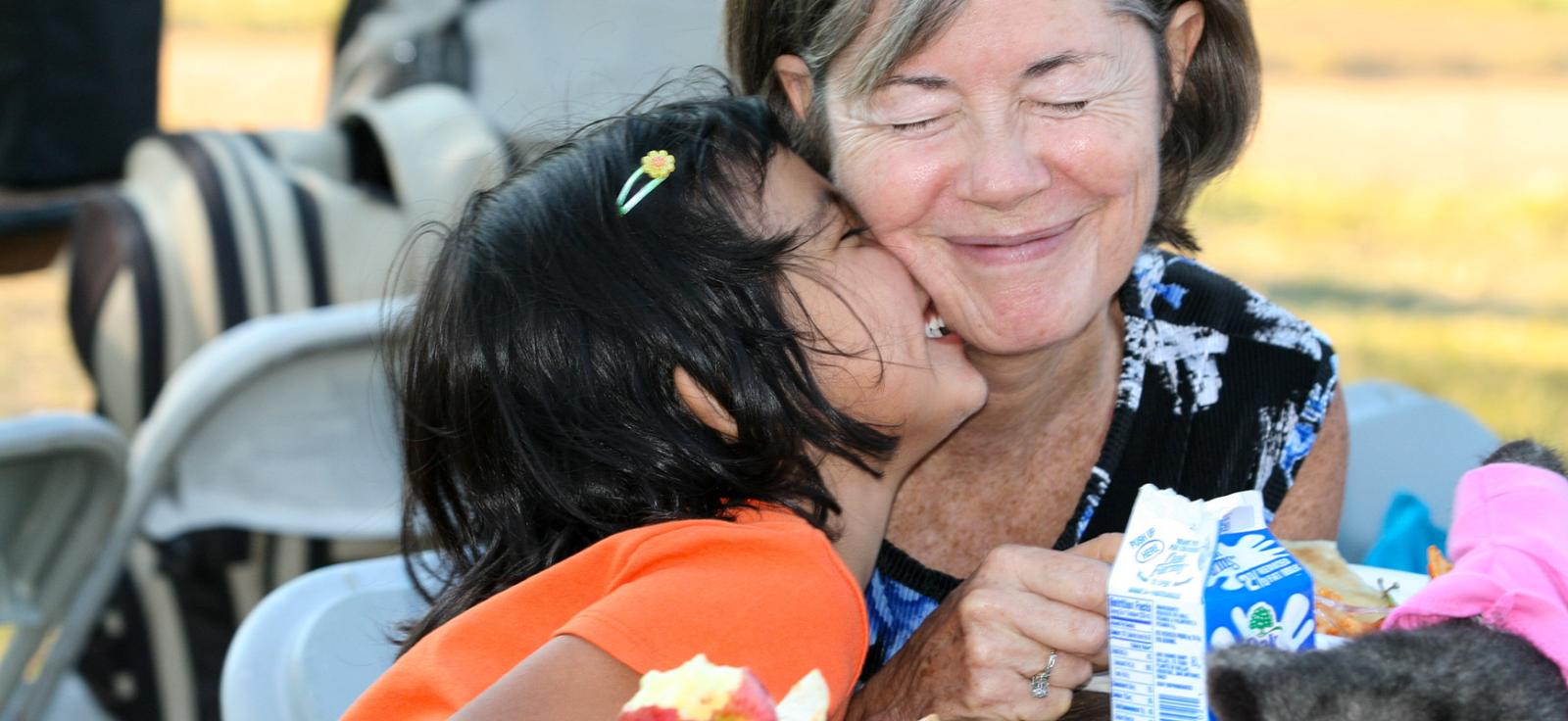 Happy grandmother and granddaughter sharing a cheerful moment