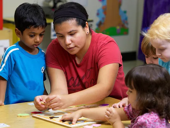 teacher helping kids